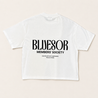 A white short-sleeve t-shirt with black printed text reading 'BLUESOR MEMBERS' SOCIETY' on the front, laid flat against a light beige background.